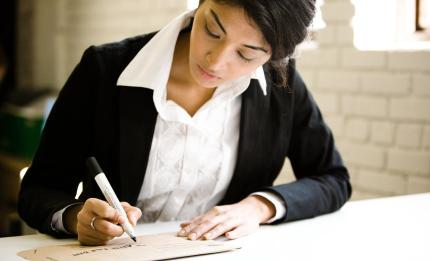 woman writing on paper