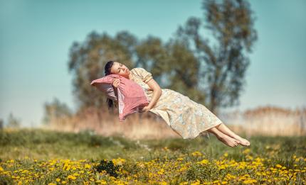 a woman sleeping in mid air