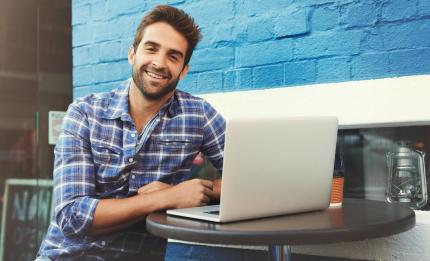 Man sitting at a desk with a computer open