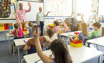 two teachers and students in a classroom