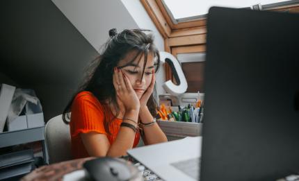 Girl looking at computer - fed up