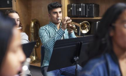 Man playing a trumpet in an orchestra