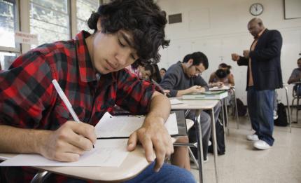 Boy writing in a classroom