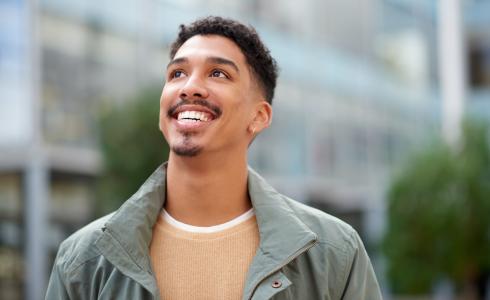 A man looks up, smiling