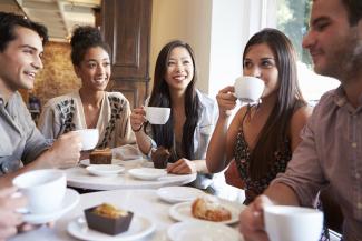 Group of people having coffee and cake