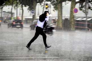 Man walking in downpour