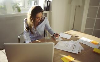 Woman writing at her desk