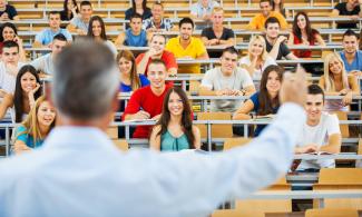 Teacher talking to students in a podium