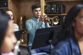 Man playing a trumpet in an orchestra